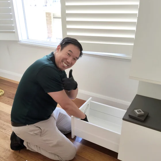 Andy, founder of Gumnut Cleaning, cleaning a kitchen bench