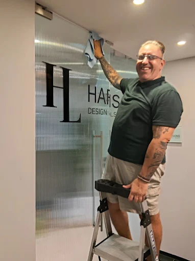 Sebastian cleaning a glass partition